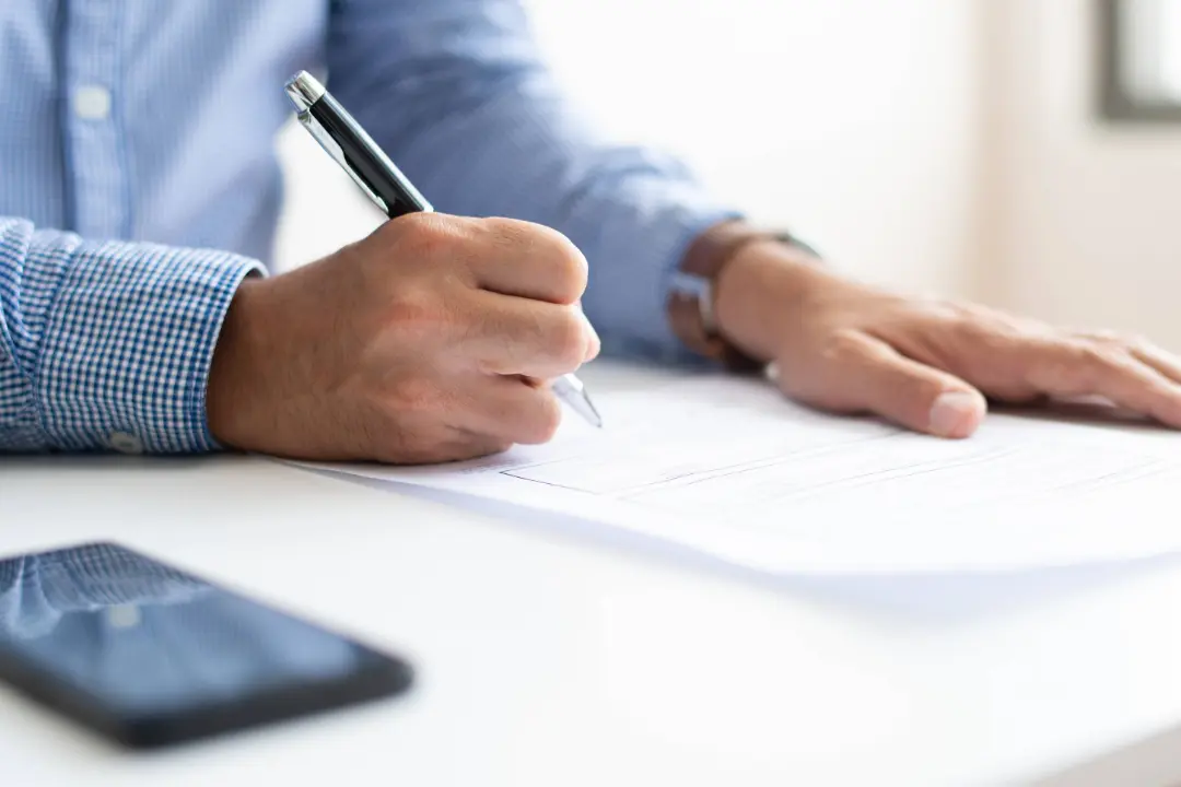 Healthcare professional completing documentation for a shared-savings contract